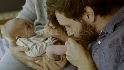 Buy stock photo Parents, newborn and father kiss baby and playing as love, care or bonding in a home as fun affection together. Happiness, dad and mother relax in bedroom kid toes or feet as family in house