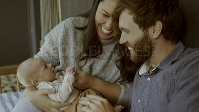 Buy stock photo Happy, newborn and parents with baby as love, care or bonding in a home as affection together. Happiness, support and couple relax in living room with kid as family in house for childcare and comfort