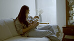 Relax, love and mother with her baby on sofa for comfortable bonding or resting in living room. Smile, care and young mom holding her infant, newborn or child with happiness in lounge of family home.
