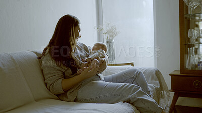 Buy stock photo Relax, love and mother with her baby on sofa for comfortable bonding or resting in living room. Smile, care and young mom holding her infant, newborn or child with happiness in lounge of family home.