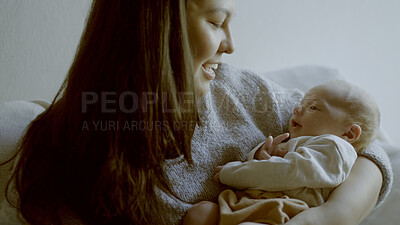Buy stock photo Sweet, love and mother holding her newborn on sofa for relaxing, bonding and resting in living room. Smile, happy and young mom with her infant, baby or child with happiness in lounge of family home.