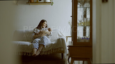 Buy stock photo Smile, care and a mother with a baby on the sofa of a living room for bonding or love. House, family and a young mom with a newborn child on the lounge couch for holding in motherhood and calm
