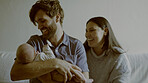 Happy, laugh and parents with baby in living room for bonding and nap time together at home. Love, smile and young mother an father holding newborn, infant or child to sleep on a sofa at family house