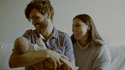Buy stock photo Happy, laugh and parents with baby in living room for bonding and nap time together at home. Love, smile and young mother an father holding newborn, infant or child to sleep on a sofa at family house