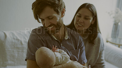 Buy stock photo Mother, father and infant baby on a sofa in the living room of their home together for love, care or bonding. Family, smile and relax with happy parents holding their cute newborn chid in a house