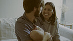 Happy, smile and parents with newborn on a sofa for bonding and nap time together at home. Love, care and young mother an father holding baby, infant or child to sleep in living room of family house.