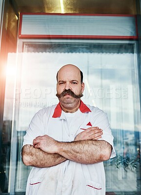 Buy stock photo Portrait, man and butcher at shop with arms crossed at small business startup. Worker, confidence and meat seller at store with serious face for retail inflation with professional outdoor in France