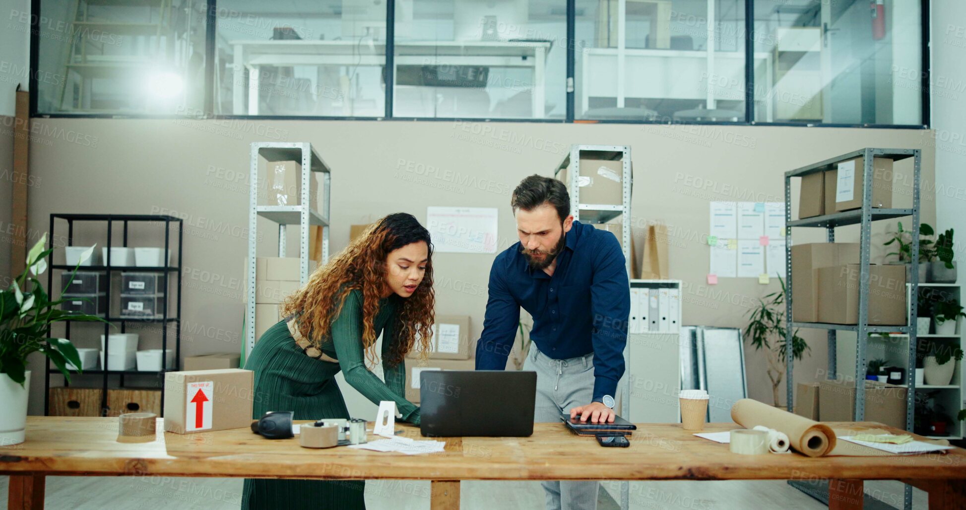 Buy stock photo Man, woman and laptop in warehouse, boxes and problem solving with teamwork for logistics. People, reading and inventory with computer, collaboration and review stats with stock for supply chain