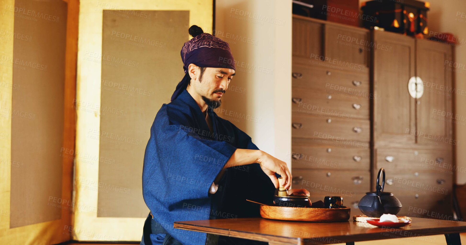 Buy stock photo Man, preparation and tea ceremony in Japan for tradition, culture and matcha in home with relax. Male person, ritual and bowl for mindfulness, zen and buddhism with spiritual, respect and harmony