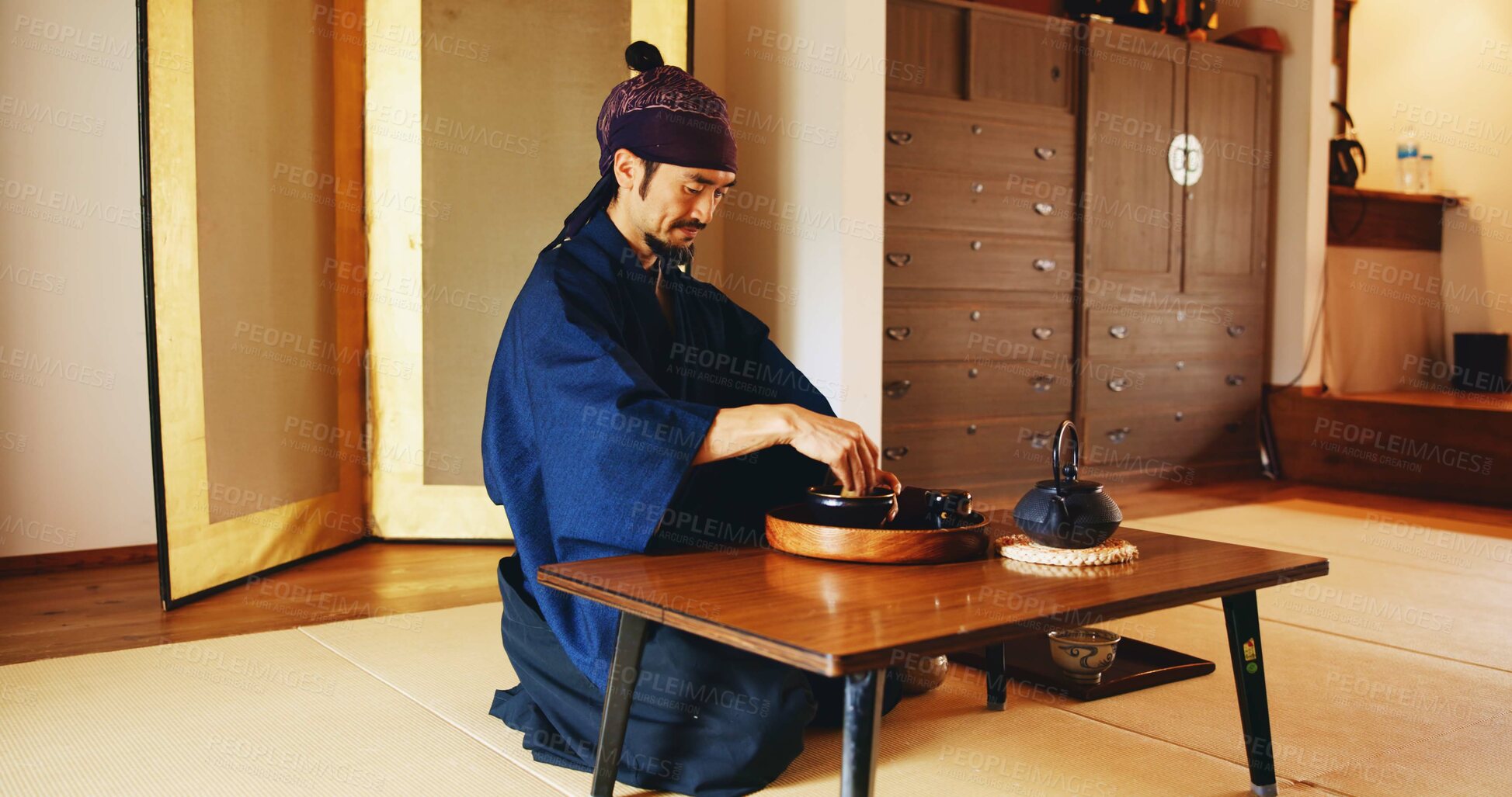 Buy stock photo Man, relax and tea ceremony for tradition, culture and matcha in home with preparation in Japan. Male person, ritual and bowl for mindfulness, zen and buddhism with spiritual, respect and harmony