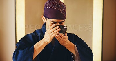 Buy stock photo Man, drinking and tea ceremony in Japan for tradition, culture and matcha in home with preparation. Male person, relax and bowl for mindfulness, zen and buddhism with spiritual, respect and harmony