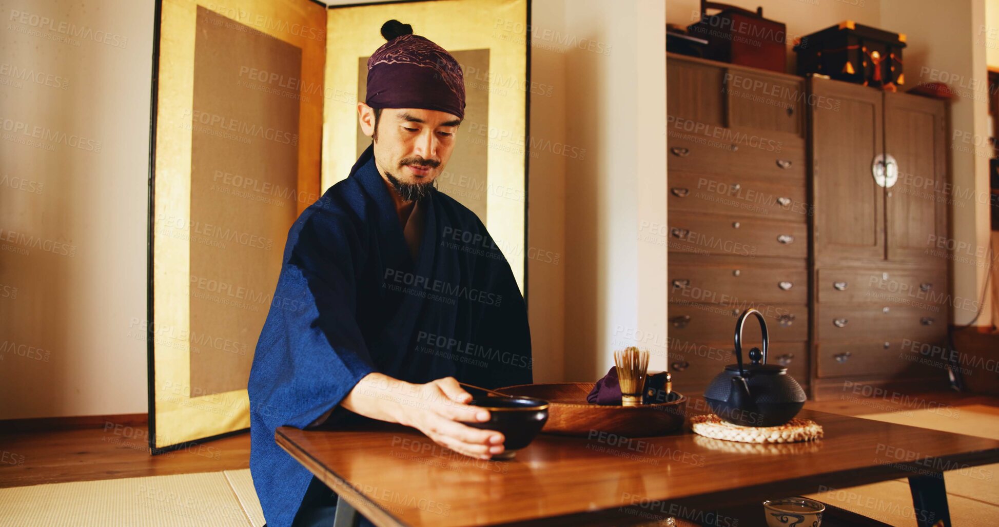 Buy stock photo Man, relax and tea ceremony for matcha, culture and tradition in home with preparation in Japan. Male person, ritual and bowl for mindfulness, zen and buddhism with spiritual, respect and harmony