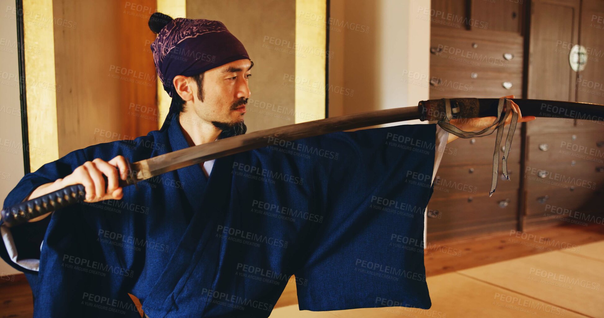 Buy stock photo Dojo, sheath and sword with Samurai man in Japan for combat, martial arts or training, Discipline, Kenjutsu and weapon with Japanese person in kendogi for culture, exercise or practice routine