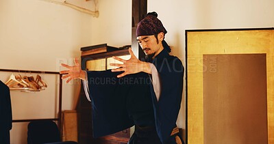 Buy stock photo Aikido, breathing and meditation with man in dojo to practice martial arts or mindfulness. Awareness, balance and chakra with Samurai person in studio for culture, heritage or Japanese tradition