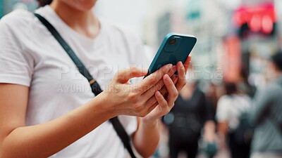 Buy stock photo Hands, phone and woman online in city to check text, social media or blog post on account in Japan. Closeup, mobile and person outdoor for communication, notification or download chat app on internet