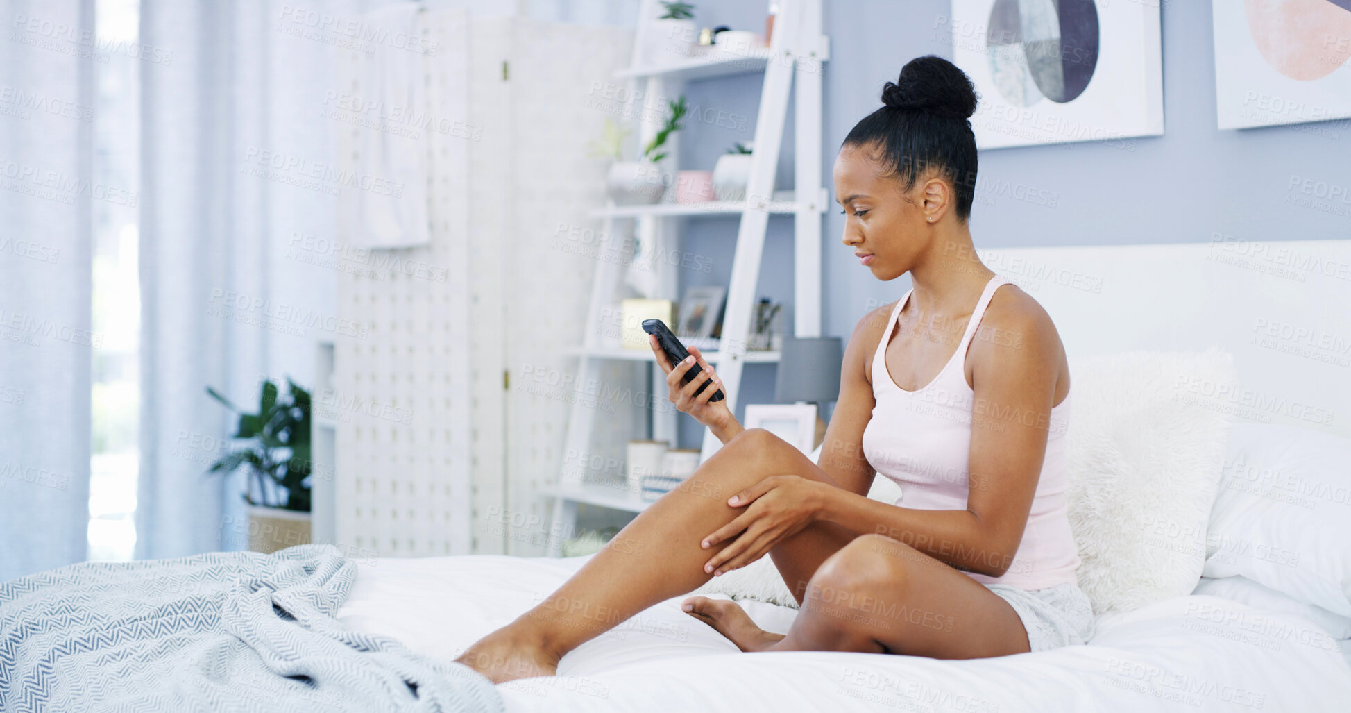 Buy stock photo Phone, relax and woman in bedroom, reading message or watch video on social media. Bed, home and girl on mobile app for chat, communication and check notification for streaming subscription service