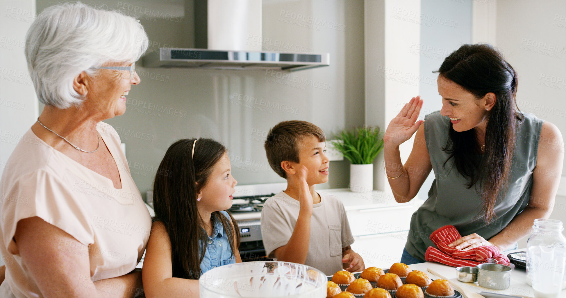 Buy stock photo Kitchen, family and baking in home with high five for muffin recipe success, celebration and learning support. Women, children and hand gesture for bonding, development goals and helping with cooking