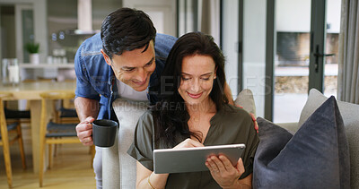 Buy stock photo Home, coffee and couple with tablet for scroll, streaming service and movie choice for entertainment. Sofa, man and woman with digital for website subscription, partner opinion and bonding with tea