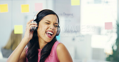 Buy stock photo Business, woman and headphones with singing in office for audio playlist, music track and work break. Creative employee, energy and radio at desk for entertainment, streaming sound and album song
