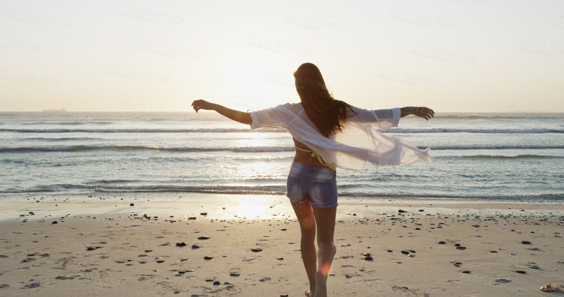 Buy stock photo Travel, girl and freedom with walking at beach for summer adventure, fresh air or holiday celebration. Back, person or stretching arms by ocean for vacation getaway, journey or weekend trip in nature
