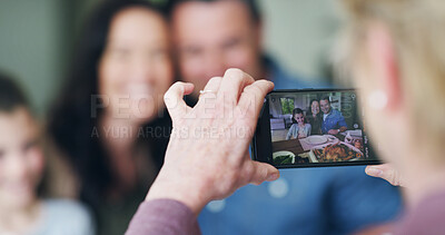 Buy stock photo Hand, phone and picture of family in home for bonding, memory or social media post together. Technology, connection and person with cellphone for photography at lunch for profile picture in house.