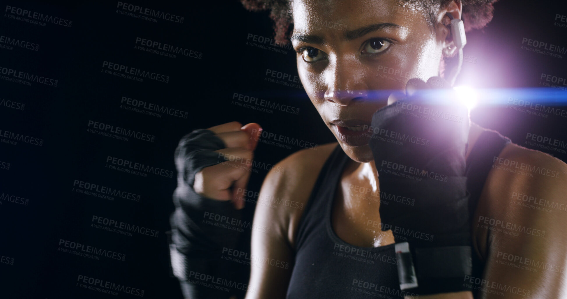 Buy stock photo Woman, boxer fighter and studio for exercise, sweating action and lens flare on black background. African person, performance training and strong power with martial arts, space and sports earphones