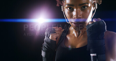 Buy stock photo Woman, boxer fighter and studio for challenge, sweating and lens flare on black background. African person, performance training and strong power with martial arts, portrait and sports earphones