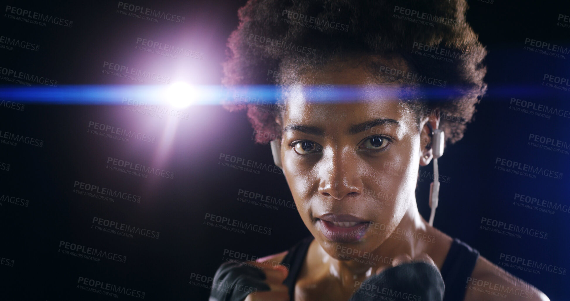Buy stock photo Woman, boxer fighter and studio for workout, sweating and lens flare on black background. African person, performance training and strong power with martial arts, portrait and sport song on earphones