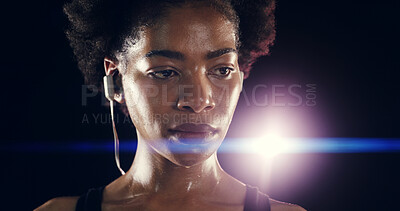 Buy stock photo Earphones, fitness and black woman at night for training, exercise and intense workout. Sports, lens flare and face of person sweating for wellness, health and listening to music on dark background