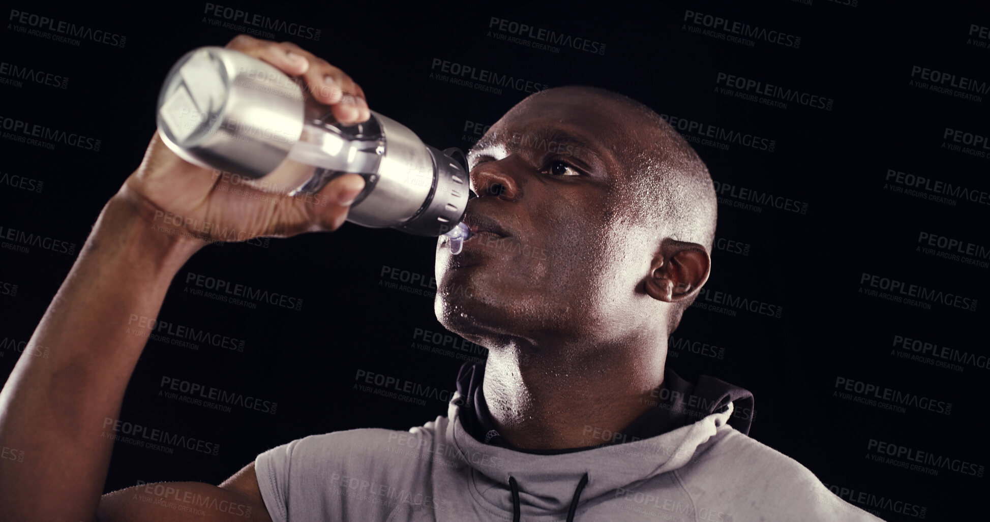 Buy stock photo Fitness, drinking water and black man in studio for training, exercise and cardio workout. Sports, thirsty and person with bottle for hydration for wellness, health and performance on dark background