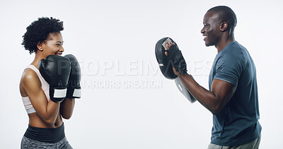 Buy stock photo Man, woman and boxing with coach in studio, smile or gloves with pads for punching by white background. African people, happy or training for self defence with martial arts, exercise and combat sport