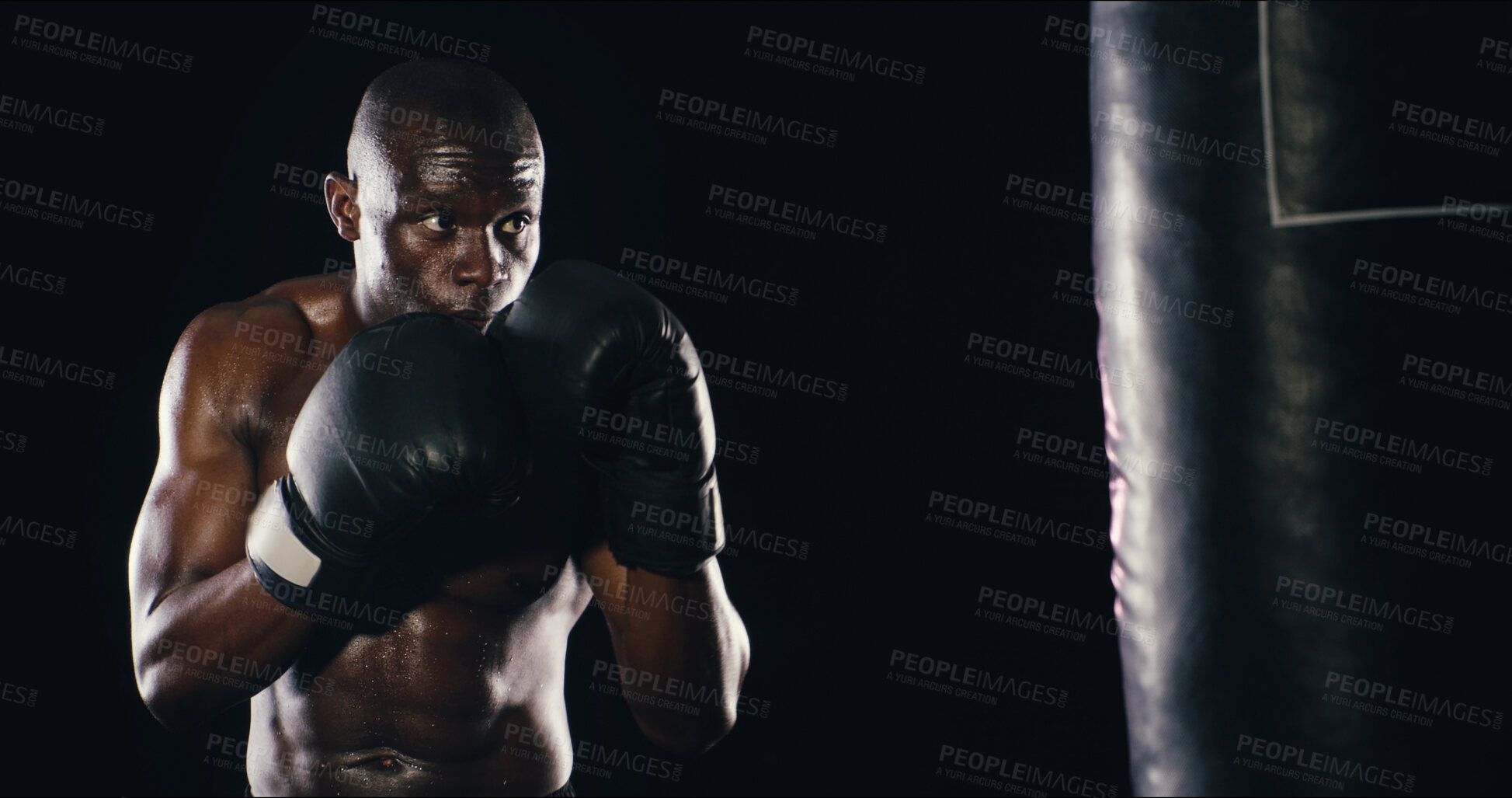 Buy stock photo Black man, fighter and studio with boxing bag, fitness and battle courage on background. Male person, performance training and strong power with martial arts, warrior action and athlete for sports