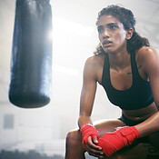 Fitness, boxer and tired woman on break in gym for intense workout ...