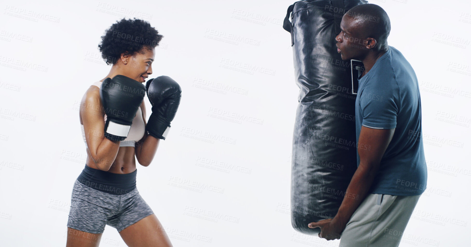 Buy stock photo Woman, man and boxing coach with punching bag, support or training for fitness by white background. African people, exercise and mentor with martial arts equipment, power or combat sport in studio