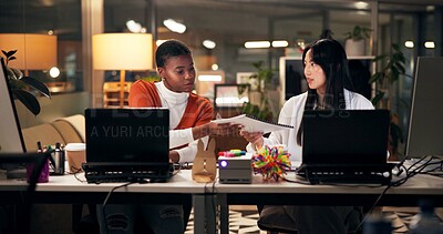 Buy stock photo Business women, documents or night with laptop for project report, review or web design at office. Female people, designers or colleagues working late with paperwork for proposal or idea at workplace