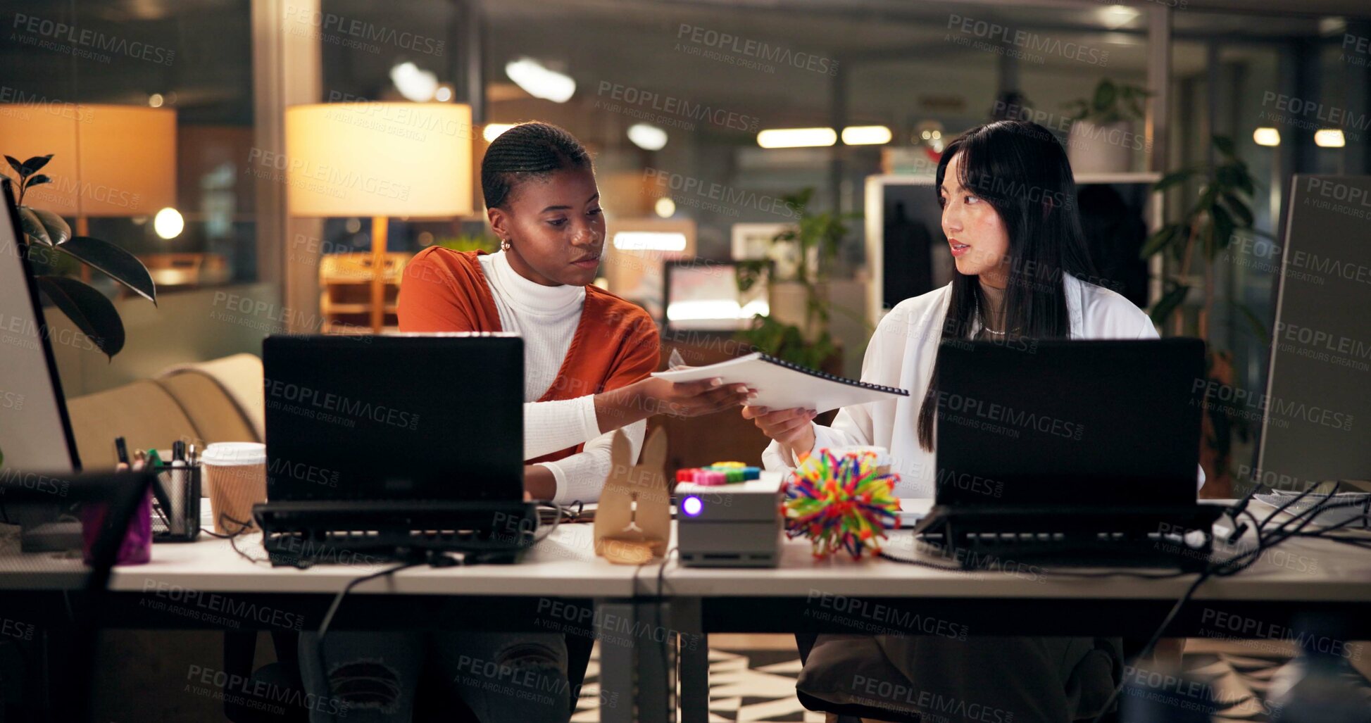 Buy stock photo Business women, documents or night with laptop for project report, review or web design at office. Female people, designers or colleagues working late with paperwork for proposal or idea at workplace