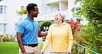 Nurse, outdoor and happy with old woman and walker for rehabilitation, healthcare or helping. Medical, support and caregiver with person with a disability in nursing home for elderly care and trust
