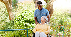 Senior woman, nurse or walking with wheelchair for support or assisted living in outdoor garden. Happy, medical worker or assistant with old patient or person with disability for fresh air in nature