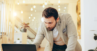Buy stock photo Man, reading and typing with laptop in office for planning, review or email at interior design agency. Person, computer and deadline for renovation project, decision and feedback at startup company