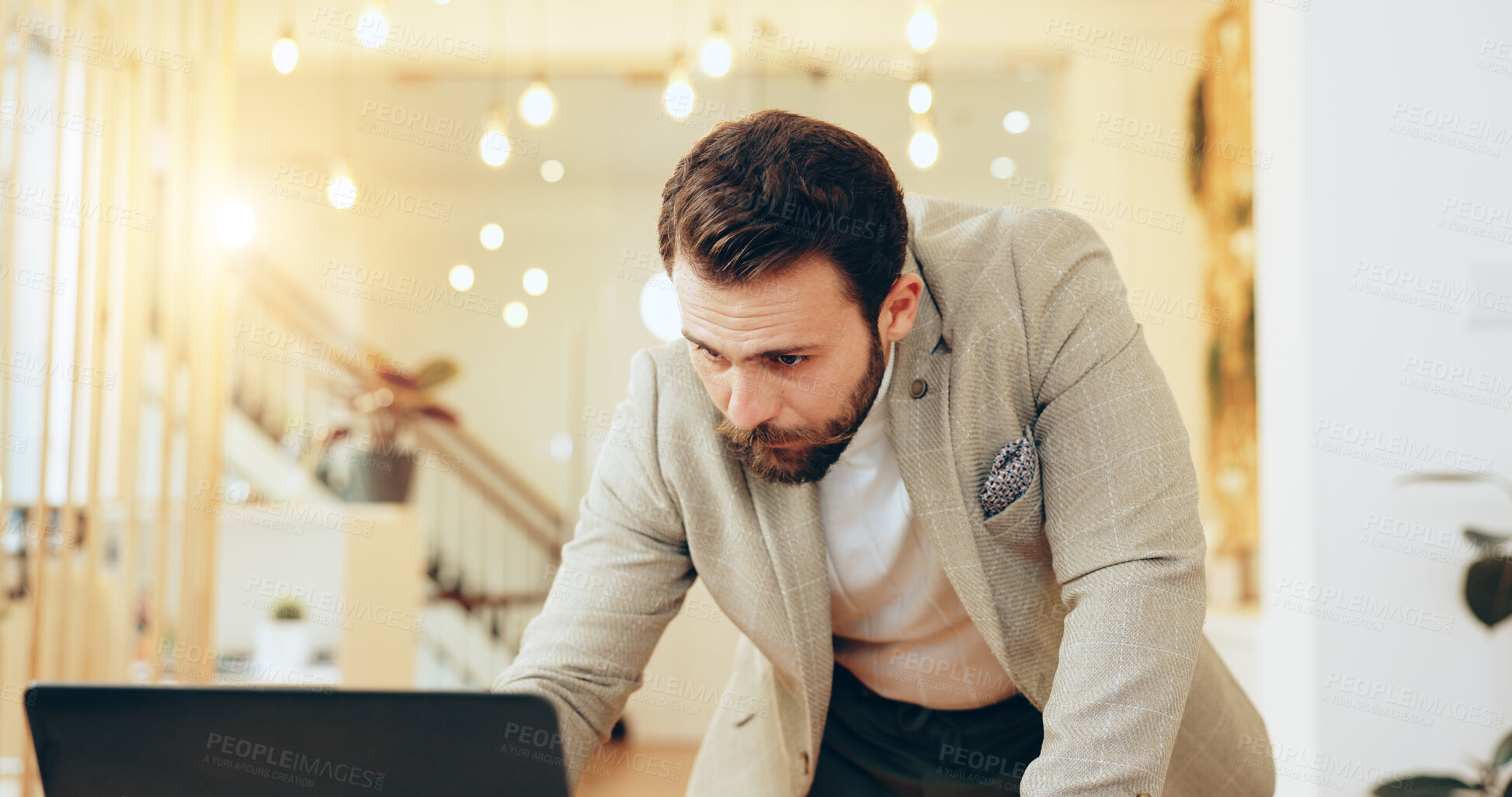 Buy stock photo Man, reading and typing with laptop in office for planning, review or email at interior design agency. Person, computer and deadline for renovation project, decision and feedback at startup company