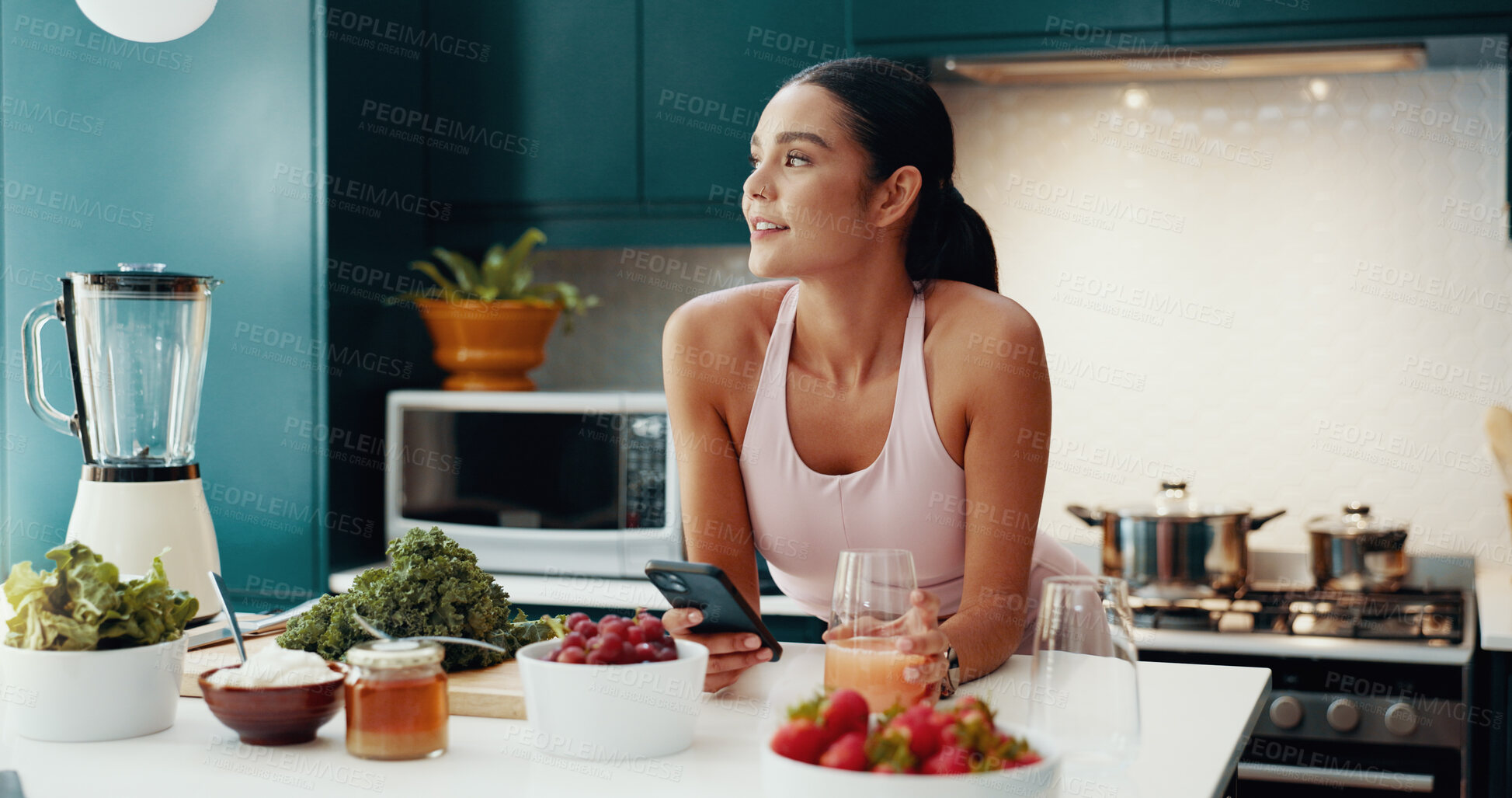 Buy stock photo Cellphone, thinking and woman with smoothie in kitchen for health, wellness and diet breakfast. Happy, idea and female person with phone for nutrition juice recipe with vegetables and fruit in home.
