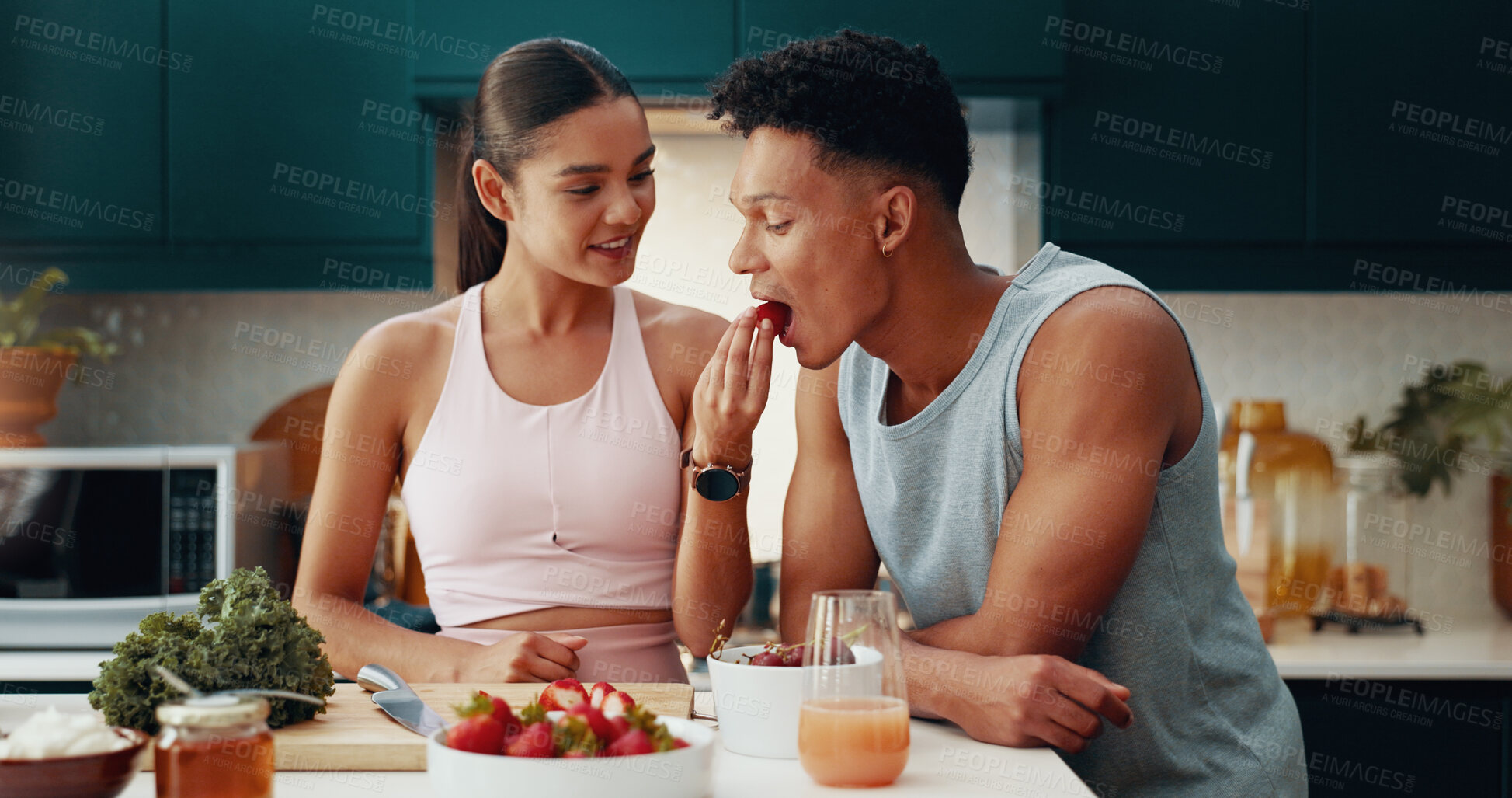 Buy stock photo Couple, feeding and fruit for fitness at house of healthy meal, nutrition diet and bonding together. People, eating and strawberry for breakfast snack, morning detox and weight loss of vegan wellness