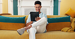 Tablet, smile and man on sofa in home with email for university admission with education. Happy, digital technology and male student reading communication for college acceptance in living room.