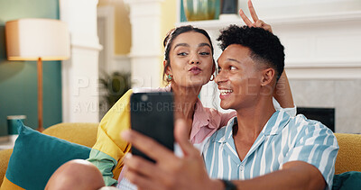 Buy stock photo Couple, selfie and joke with peace sign, home and sofa for social media post. Man, woman and excited for happy memory, profile picture and emoji for bonding or online video call together on couch