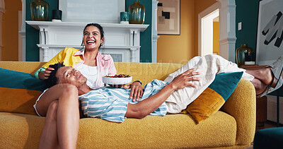 Buy stock photo Laugh, eating and couple with fruit on sofa for bonding, love and connection together in home. Happy, marriage and people with healthy snack with watching movie, film or show in living room at house.