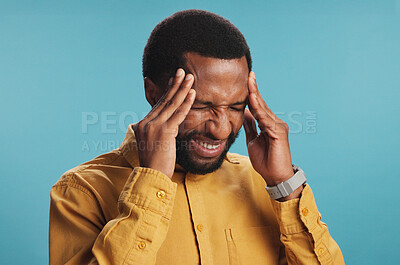 Buy stock photo Stress, anxiety and black man with headache in studio, tension or pressure on blue background. African person, model or guy with migraine, illness or frustrated with brain fog, temple massage or pain