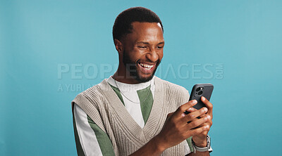 Buy stock photo Online, black man and laughing with phone in studio for comic text message, social media meme or funny joke. Mockup space, person or happy with smartphone for communication or chat on blue background