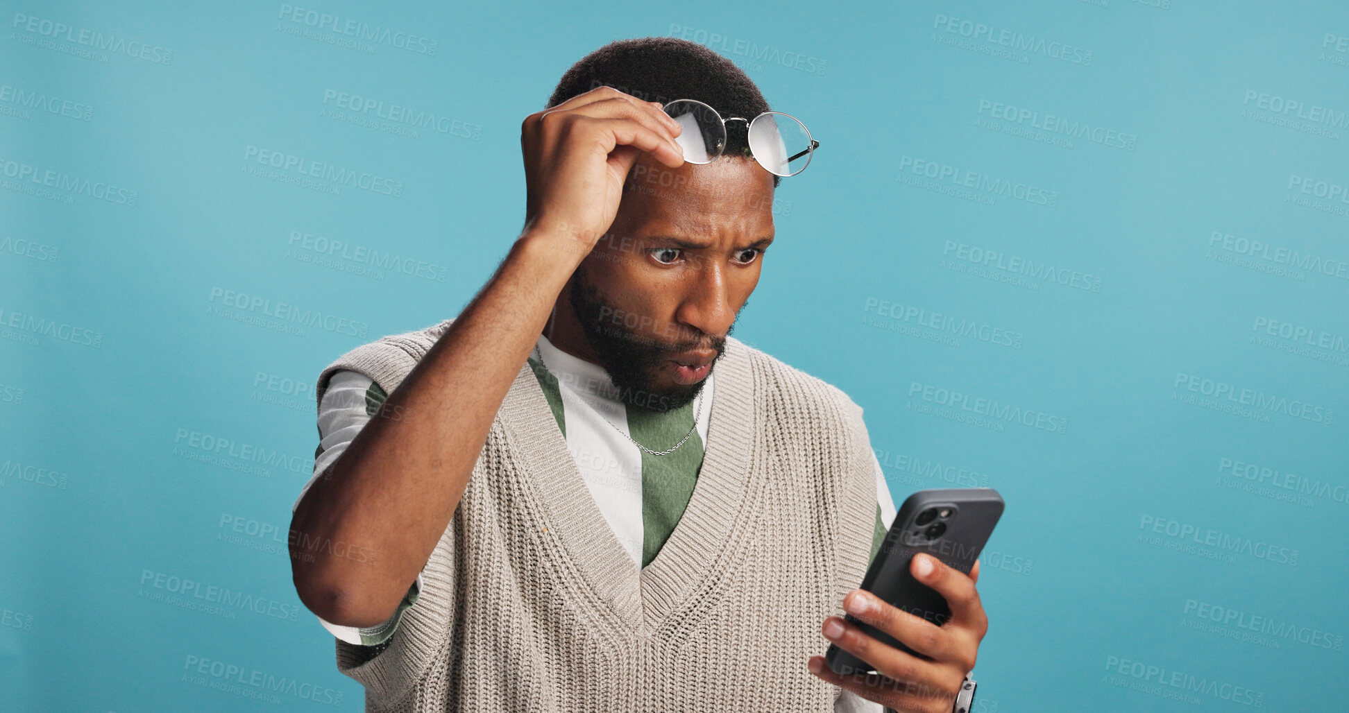 Buy stock photo Surprise, shock and black man with phone for news, results or omg for college acceptance. Wow, mobile and person reading promo, unexpected notification or wtf emoji for win on blue studio background