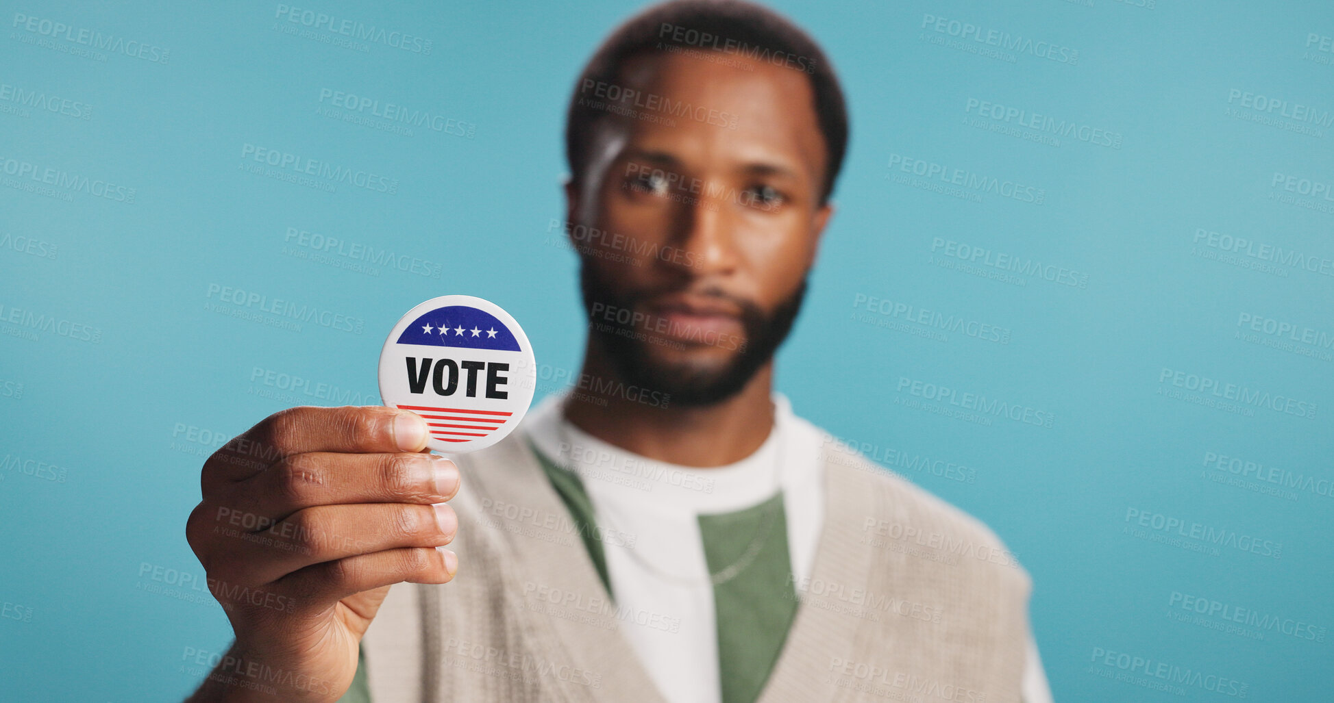 Buy stock photo Black man, vote badge and freedom in studio, politics support and message for election registration. Male person, patriotic representative and pin on blue background, campaign volunteer and portrait