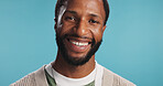 Portrait, smile and black man in studio, confidence and positive mindset on blue background. African person, guy and model with fashion, beard or stylish outfit with pride, casual outfit and cheerful